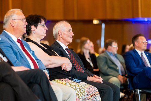 Menschen sitzen nebeneinander im bestuhlten Saal der Stadthalle Neuss.