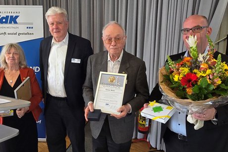 Irene Stengel und Günter Maier stehen neben dem Vorsitzenden Peter Jeromin und dem Geschäftsführer Marc Thiele, der einen großen Blumenstrauß hält.