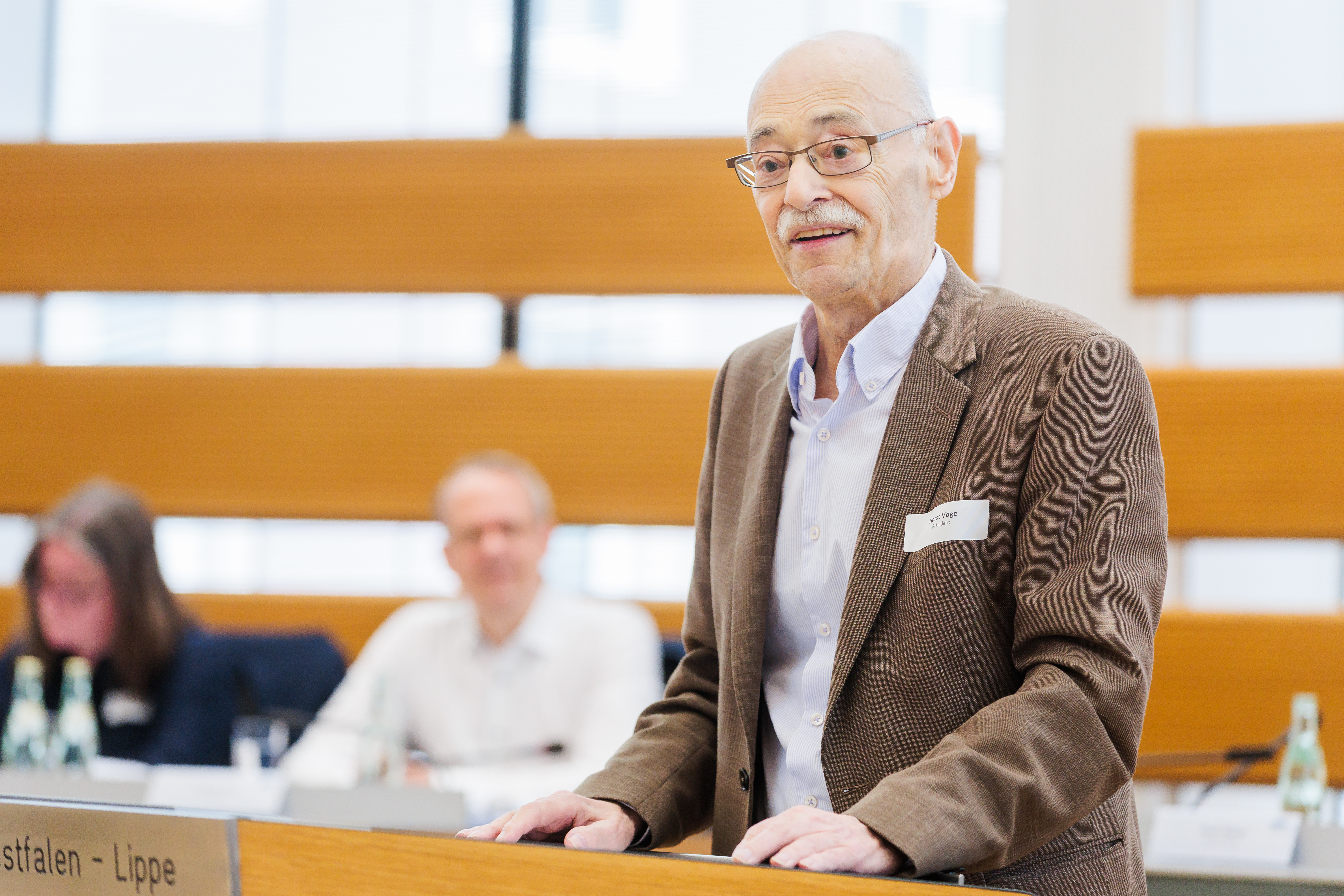 VdK-NRW-Präsident Horst Vöge steht an einem Rednerpult und spricht.