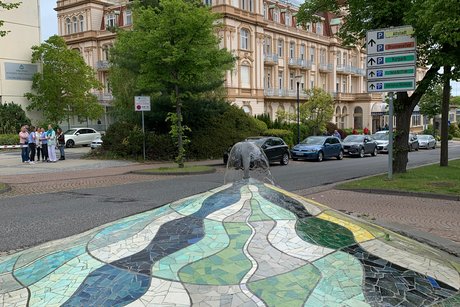 Schloss&auml;hnliches Geb&auml;ude mit Mosaikbrunnen im Vordergrund