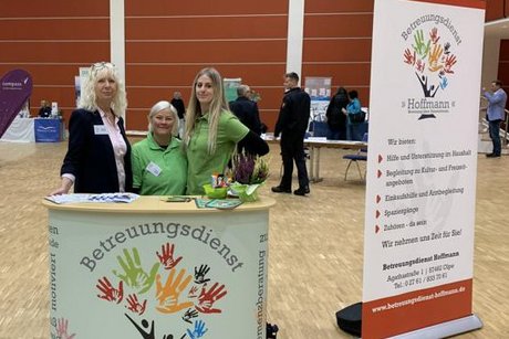 Das Bild zeigt drei Vertreterinnen eines Betreuungsdienstes am Messestand