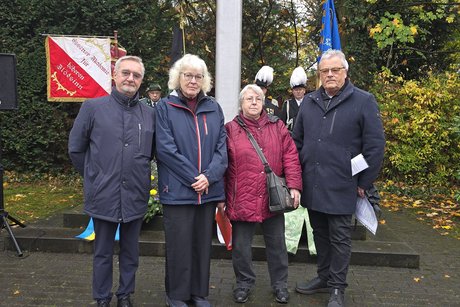 4 Personen stehen zusammen.