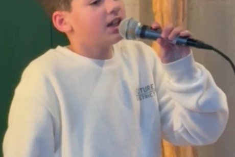 Der Musiker Thibo Hoever singt mit Mikrofon bei der Weihnachtsfeier des VdK in der Landwirtschaft Bolten.