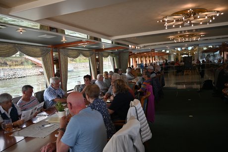 Teilnehmer auf dem Schiff beim gemeinsamen Mittagessen