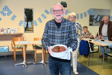 Der frisch zubereitete Leberk&auml;se wird von Herrn Steinbrink pr&auml;sentiert