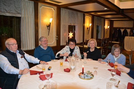 Mitglieder sitzen am Tisch beim Weihnachtsessen
