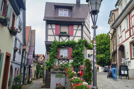 Blick in zwei Altstadtgassen in Gengenbach; rechts und links Fachwerkhäuser; in der Mitte ein schmales Haus zwischen den Gassen.