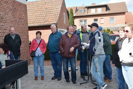 Menschen stehen zusammen und hören den Fleischern zu