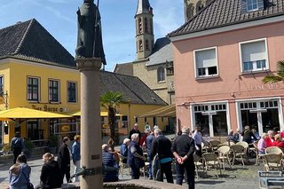 Ein Brunnen mit Bischofsskulptur auf dem Marktplatz der Xantener Altstadt.