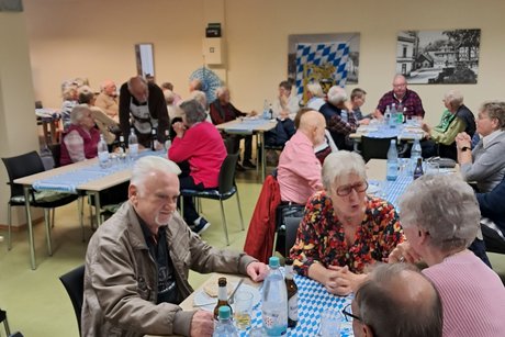 Mitglieder sitzen an Tischen