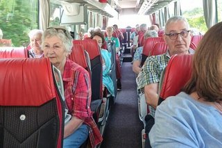 Eine Gruppe von Menschen sitzt im Reisebus.