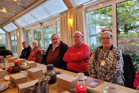 Hier sitzen Mitglieder am Tisch und hören die Ansprache von Klaus Meiers