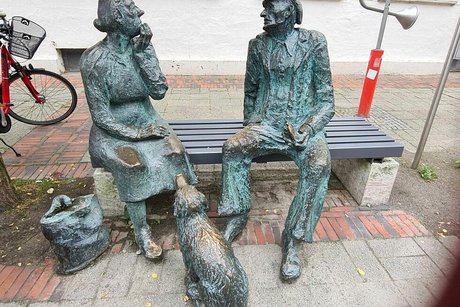 Die Bronze-Skulpturengruppe "Oma und Opa" auf einer Bank in der Fußgängerzone von Aurich.