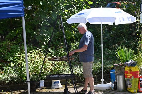Ein Mann steht am Grill